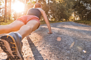 Young sport woman does pushups